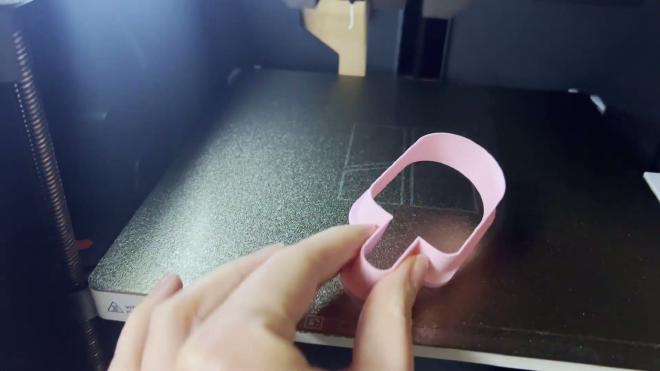 Pink custom cookie cutter being removed from a Bambu Lab printer