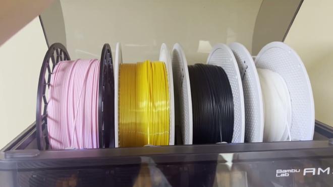 White PLA filament loaded in a Bambu Lab AMS for cake topper printing