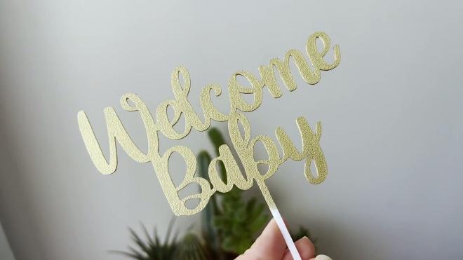 Finished metallic gold Welcome Baby 3D printed cake topper
