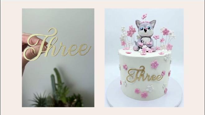 Gold Three plaque style cake topper attached to a finished cake