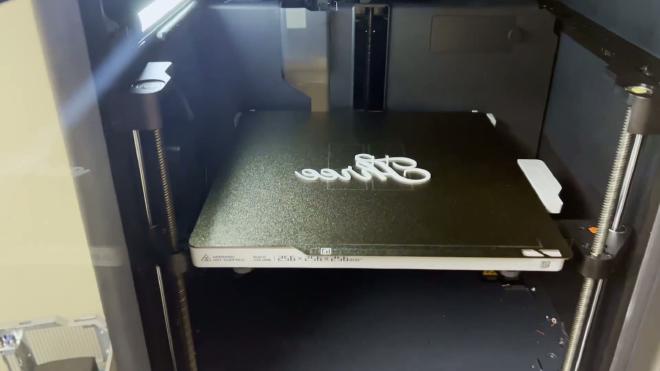 White PLA cake topper printing on a Bambu Lab 3D printer