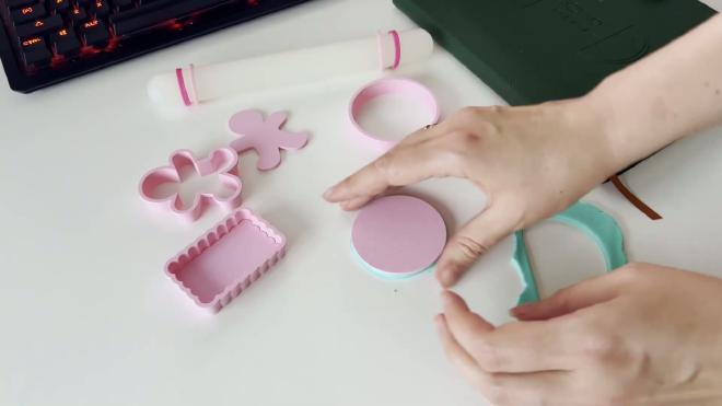 3D printed cookie cutters and fondant test shapes on a white workspace