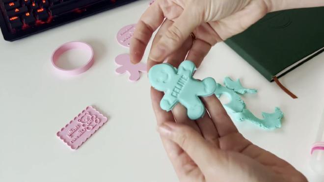 Holding a personalized Celine gingerbread fondant cutout from a stamp cookie cutter