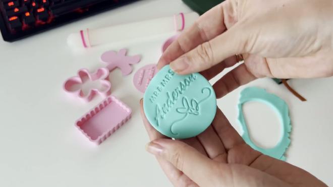 Blue fondant circle embossed with MR and MRS Anderson from a wedding stamp cookie cutter